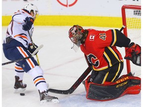 Calgary Flames goaltender Mike Smith makes a save on Connor McDavid of the Edmonton Oilers at the Scotiabank Saddledome in Calgary on Tuesday, March 13, 2018. (Al Charest)