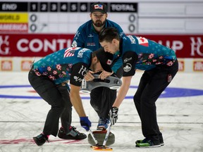 Team North America skip Reid Carruthers of Winnipeg, lead Colin Hodgson,second Derek Samagalski, brush the stone during a match against Team World at the 2017 Continental Cup