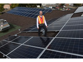 EDMONTON, ALBERTA SEPTEMBER 9, 2015: Clifton Lofthaug, Owner of Great Canadian Solar Ltd., with the new solar panels on the roof of the Devon Community Centre.