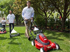 Mayor Don Iveson demonstrates how to leave grass clippings on the lawn to improve soil nutrients and reduce waste.