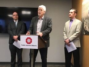 Larry Booi (centre), president of the board of Public Interest Alberta, speaks in Edmonton March 19, 2018, about four school districts' policies that should protect LGBTQ students and staff. University of Alberta Prof. Kristopher Wells (left) and PIA executive director Joel French joined Booi.