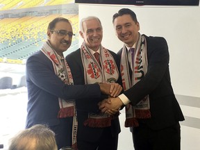 (left to right) Amarjeet Sohi, federal minister of infrastructure and communities, Steven Reed, president of Canada Soccer and co-chair of the United 2026 bid committee, and Ward 10 city councillor Michael Walters join hands to announce  Edmonton as one of three candidate host cities for the 2026 FIFA World Cup at Commonwealth Stadium in Edmonton, AB on Friday, March 16, 2018.