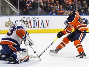 New York Islanders goalie Christopher Gibson (33) stops Edmonton Oilers' Connor McDavid (97) during overtime NHL action in Edmonton on Thursday March 8, 2018.
