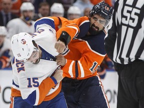 New York Islanders' Cal Clutterbuck (15) and Edmonton Oilers' Jujhar Khaira (16) fight during first period NHL action in Edmonton on Thursday March 8, 2018.