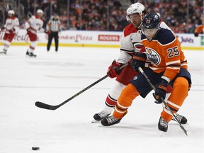 Edmonton's Darnell Nurse (25) battles Carolina's Justin Williams (14) during the first period of a NHL game between the Edmonton Oilers and the Carolina Hurricanes at Rogers Place in Edmonton, Alberta on Tuesday, October 17, 2017.