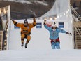 Gabriel Andre, from Edmonton, in orange and Reed Whiting, in blue, are the first down the track before races begin during Red Bull Crashed Ice competition in downtown Edmonton, Alberta on Friday, March 9, 2018. Photo by Ian Kucerak/Postmedia