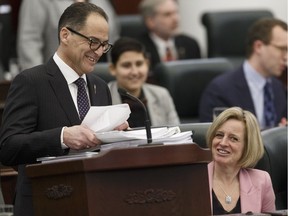 Alberta Finance Minister Joe Ceci delivers Budget 2018 while Premier Rachel Notley listens on the floor of the Alberta Legislature in Edmonton, on Thursday, March 22, 2018.