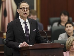 Alberta Finance Minister Joe Ceci (left) delivers Budget 2018 while Premier Rachel Notley listens in the Alberta Legislature in Edmonton, on Thursday, March 22, 2018. Photo by Ian Kucerak/Postmedia