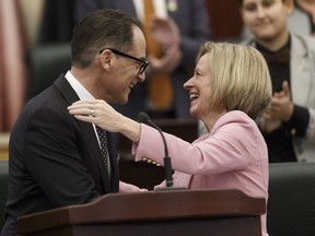 Alberta Finance Minister Joe Ceci (left) hugs Premier Rachel Notley after delivering Budget 2018 in the Alberta Legislature in Edmonton, on Thursday, March 22, 2018.