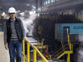 Prime Minister Justin Trudeau walks in the Direct Strip Production Complex during a tour at Essar Steel Algoma in Sault Ste. Marie, Ont., on Wednesday, March 14, 2018.