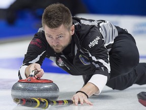 Wildcard skip Mike McEwen delivers a rock against Sakatchewan at the Tim Hortons Brier at the Brandt Centre in Regina on Friday, March 9, 2018. (THE CANADIAN PRESS/Andrew Vaughan)