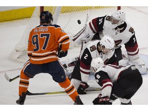 Edmonton Oilers captain Connor McDavid (97) watches the puck as it sails toward Arizona Coyotes goalie Darcy Kuemper (35) in Edmonton on Monday, March 5, 2018. (Greg Southam)