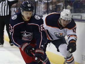 Columbus Blue Jackets' Markus Nutivaara, left, of Finland, carries the puck away from Edmonton Oilers' Ryan Strome during the first period of an NHL hockey game Tuesday, Dec. 12, 2017, in Columbus, Ohio.