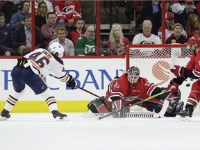 Carolina Hurricanes' Jordan Staal (11) and goalie Scott Darling (33) block as Edmonton Oilers' Pontus Aberg (46), of Sweden, shoots during the second period of an NHL hockey game in Raleigh, N.C., Tuesday, March 20, 2018.
