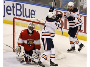 Edmonton Oilers defenceman Adam Larsson (6) celebrates his game-winning goal with teammate Ty Rattie (8) in front of Florida Panthers goaltender Roberto Luongo on Saturday, March 17, 2018, in Sunrise, Fla. The Oilers won the game 4-2.