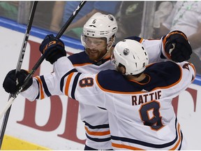 Edmonton Oilers defenceman Adam Larsson (6) celebrates his game-winning goal with teammate Ty Rattie (8) on the way to a 4-2 victory over the Florida Panthers on Saturday, March 17, 2018, in Sunrise, Fla.