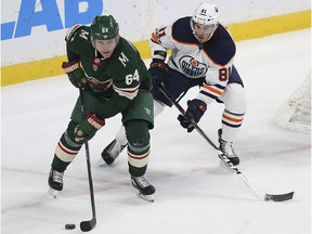 Minnesota Wild's Mikael Granlund (64) controls the puck against Edmonton Oilers' Johann Auvitu (81) in the first period of an NHL hockey game Saturday, Dec. 16, 2017, in St. Paul, Minn.