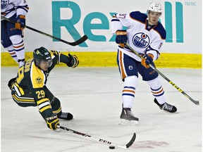 Edmonton Oilers Connor McDavid (97) shoots the puck past University of Alberta Golden Bears defenceman Dylan Bredo (29) in this file photo from an exhibition game at Rexall Place in Edmonton, on Sept. 16, 2015. (File)