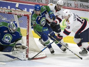 Swift Current Broncos goalie Stuart Skinner gets a pad out to make the save on Regina Pats Jake Leschyshyn as he attempts a wrap aruond in first round WHL playoffs at the Brandt Centre in Regina.