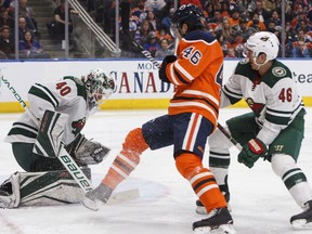 Minnesota Wild goaltender Devan Dubnyk (40) makes the save on Edmonton Oilers left wing Pontus Aberg (46) as Wild defenceman Jared Spurgeon (46) defends during second period NHL action in Edmonton, Alta., on Saturday March 10, 2018.