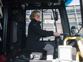Premier Rachel Notley checks out the view behind the wheel on a bus after announcing funding for a new St. Albert transit park and ride at St. Albert Place on March 26, 2018.