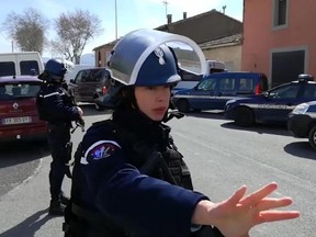 In this image taken from La Depeche Du Midi, police attend an incident in Trebes, southern France, Friday March 23, 2018.