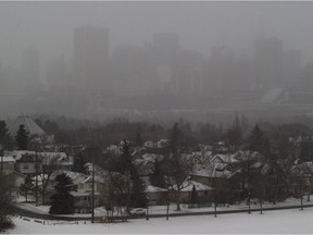 A light snowfall obscures the downtown Edmonton skyline on Saturday, Dec. 23, 2017.