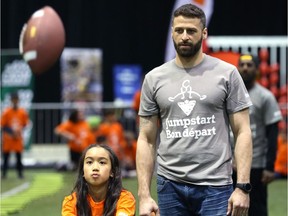 Edmonton Eskimos quarterback Mike Reilly watches students throw and catch during a Jumpstart event at the RBC Convention Centre that is part of CFL Week in Winnipeg on March 22, 2018.