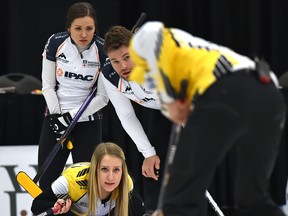 Kadriana Sahaidak watches her teammate Colton Lott sweep his rock as Laura  Crocker and Kirk Muyres observe from back in the gold-medal final of the 2018 Canadian Mixed Doubles Curling Championship at the Leduc Recreation Centre, April 1, 2018. Ed Kaiser/Postmedia