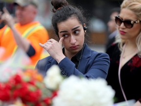 Two women pay their respects to the dead at the scene of Mondays horrific van attack that left 19 dead.