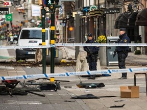 Police attend the scene of the terrorist attack where a truck crashed after driving down a pedestrian street in downtown Stockholm on April 8, 2017 in Stockholm, Sweden. A suspect has been detained following the attack after four people were killed and 15 injured when the hijacked truck crashed into the front of Ahlens department store.