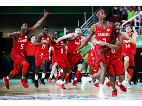 Mamadou Gueye of Canada celebrates with the team after scoring a three-pointer at the buzzer in the semi-final against New Zealand at the Gold Coast 2018 Commonwealth Games on April 14, 2018.