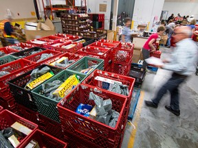 Volunteers at the Calgary Inter-Faith Food bank fill hampers at their warehouse in Calgary.