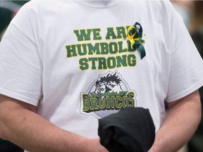A man wears a Humboldt Broncos shirt during a vigil at the Elgar Petersen Arena, home of the Humboldt Broncos, to honour the victims of a fatal bus accident, April 8, 2018 in Humboldt, Canada.