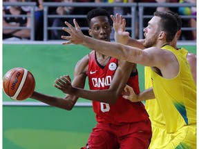 Jean-Victor Mukama of Canada, left, tries to pass around Nicholas Kay of Australia during the men's gold medal basketball game at the Gold Coast Convention and Exhibition Centre during the 2018 Commonwealth Games on the Gold Coast, Australia, Sunday, April 15, 2018.
