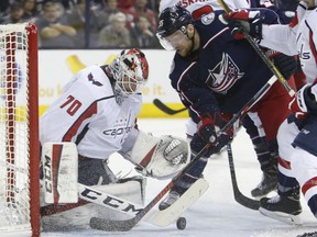 Washington Capitals goalie Braden Holtby, left, makes a save on Columbus Blue Jackets centre Mark Letestu during Game 4 of their NHL first-round playoff series on April 19, 2018, in Columbus, Ohio.