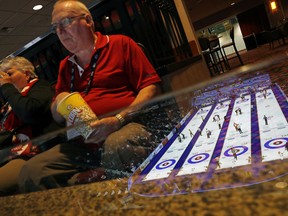 Fans watch the men's world curling championships Thursday, April 5, 2018, in Las Vegas. (AP Photo/John Locher)