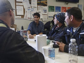 Prime Minister Justin Trudeau meets with workers at Suncor's Fort Hills facility near Fort McMurray, Alta., on Friday, April 6, 2018. THE CANADIAN PRESS/Jason Franson ORG XMIT: EDM108