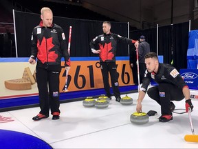 Canadian second Brett Gallant prepares to slide out of the hack while third Mark Nichols, left, prepares to sweep and skip Brad Gushue, centre, surveys the arena during Friday's practice at the men's world curling championship at the Orleans Arena in Las Vegas, Nevada, on Friday, March 30, 2018. (THE CANADIAN PRESS/Donna Spencer)