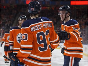 From left, Edmonton Oilers' Andrej Sekera, Ryan Nugent-Hopkins and Connor McDavid celebrate a goal against the Anaheim Ducks during NHL action on March 25, 2018, in Edmonton.