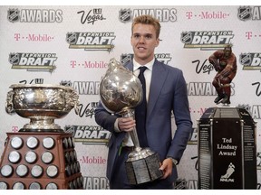 Connor McDavid of the Edmonton Oilers poses with the Art Ross Trophy, left, the Hart Memorial Trophy, center, and the Ted Lindsay Award after winning the honors during the NHL Awards, Wednesday, June 21, 2017, in Las Vegas. Edmonton Oilers superstar Connor McDavid, New Jersey Devils left-winger Taylor Hall and Colorado Avalanche centre Nathan MacKinnon were named the finalists for the Ted Lindsay Award on Thursday.