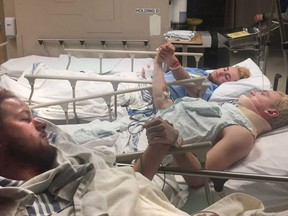 The father of Derek Patter posted this photo on Twitter of his son in hospital holding hands with Humboldt Broncos teammates Greysen Cameron and Nick Shumlanski after a bus crash outside of Tisdale, Saskatchewan that killed 14 and left 15 injured.(Twitter/rjpatter)