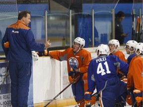 Assistant Coach Ian Herbers (left) speaks with players during the Edmonton Oilers Development Camp at Jasper Arena on July 5, 2017.
