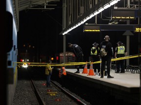 Investigators are seen at Belvedere LRT Station in Edmonton, on Wednesday, April 25, 2018 after a man's leg was nearly severed when he reportedly kicked an LRT train.