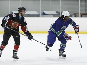 Former Edmonton Oiler Georges Laraque (right) plays for the AIM Building Maintenance team during the 4th annual Hockey Helps The Homeless Edmonton Tournament at Terwillegar Community Recreation Centre in Edmonton, Alta. on Friday, May 12, 2017. Ian Kucerak / Postmedia