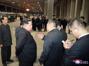 In this Wednesday, April 25, 2018, photo provided by the North Korean government, North Korean leader Kim Jong Un, centre left, speaks with China's Ambassador to North Korea Li Jinjun, centre right, as Kim visits Pyongyang Station, North Korea to see off Chinese bodies and injured in Sunday's bus crash. (Korean Central News Agency/Korea News Service via AP)