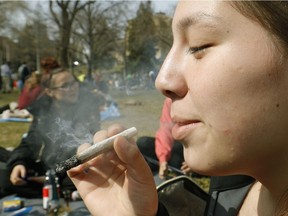 Jodie Lamb smokes at the 420 marijuana rally held on the Alberta Legislature grounds in Edmonton on Thursday April 20, 2017.