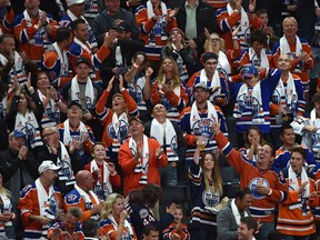 Fans celebrate a goal by Edmonton Oilers star Connor McDavid against the Calgary Flames during the season opener of NHL action at Rogers Place in Edmonton on Oct. 4, 2017.