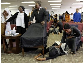 Postmedia photojournalist Larry Wong won a News Photographers Association of Canada photograph of the year award Saturday, April 28, 2018 for this picture of congregation members collapsing as they are overcome with grief during a memorial service at Solid Rock Church International in Edmonton last Sept. 24.