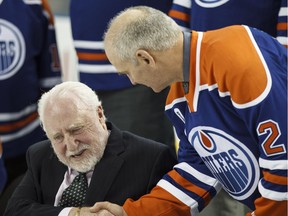 Former Oilers defenceman Lee Fogolin (right) shakes hands with former team owner Peter Pocklington during an Edmonton Oilers media availability with the members of the Stanley Cup winning 83-84 Oilers at Rexall Place in Edmonton in 2014.